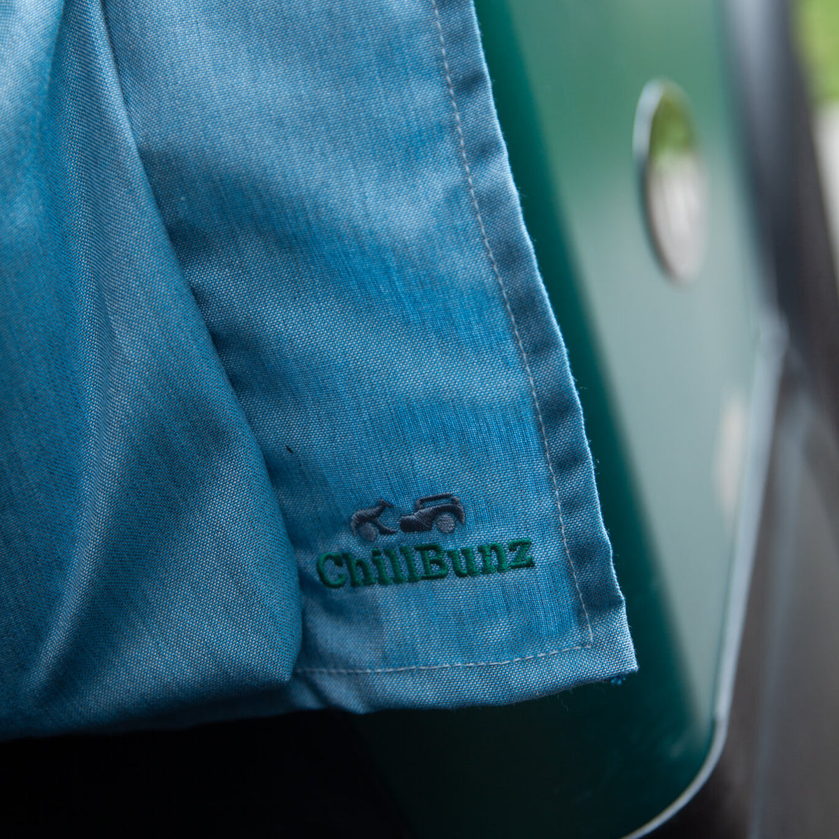 Caribbean Blue seat cover draped over a golf cart seat with embroidered ChillBunz logo