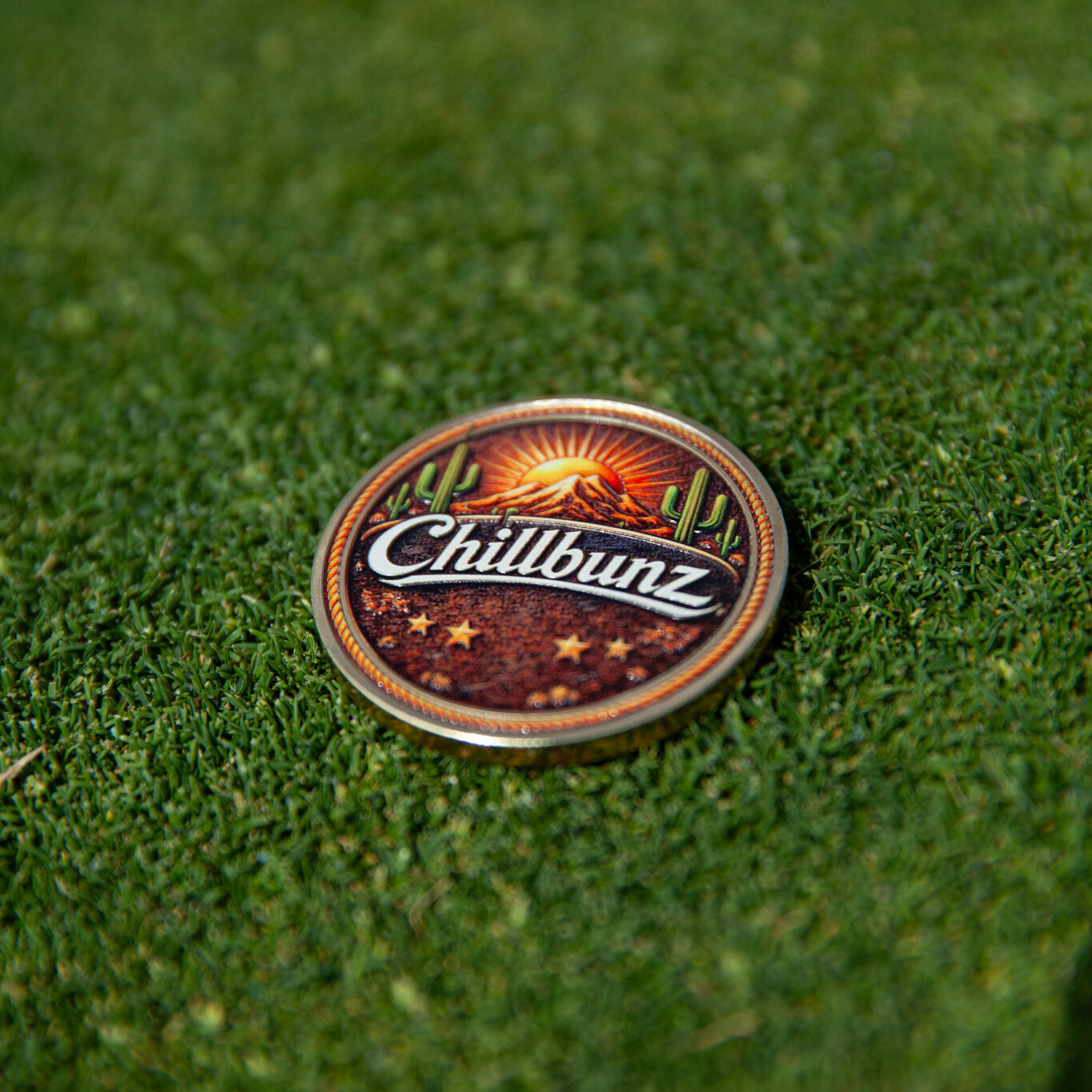 Desert Classic ball marker, cactus and sunset design, on the green