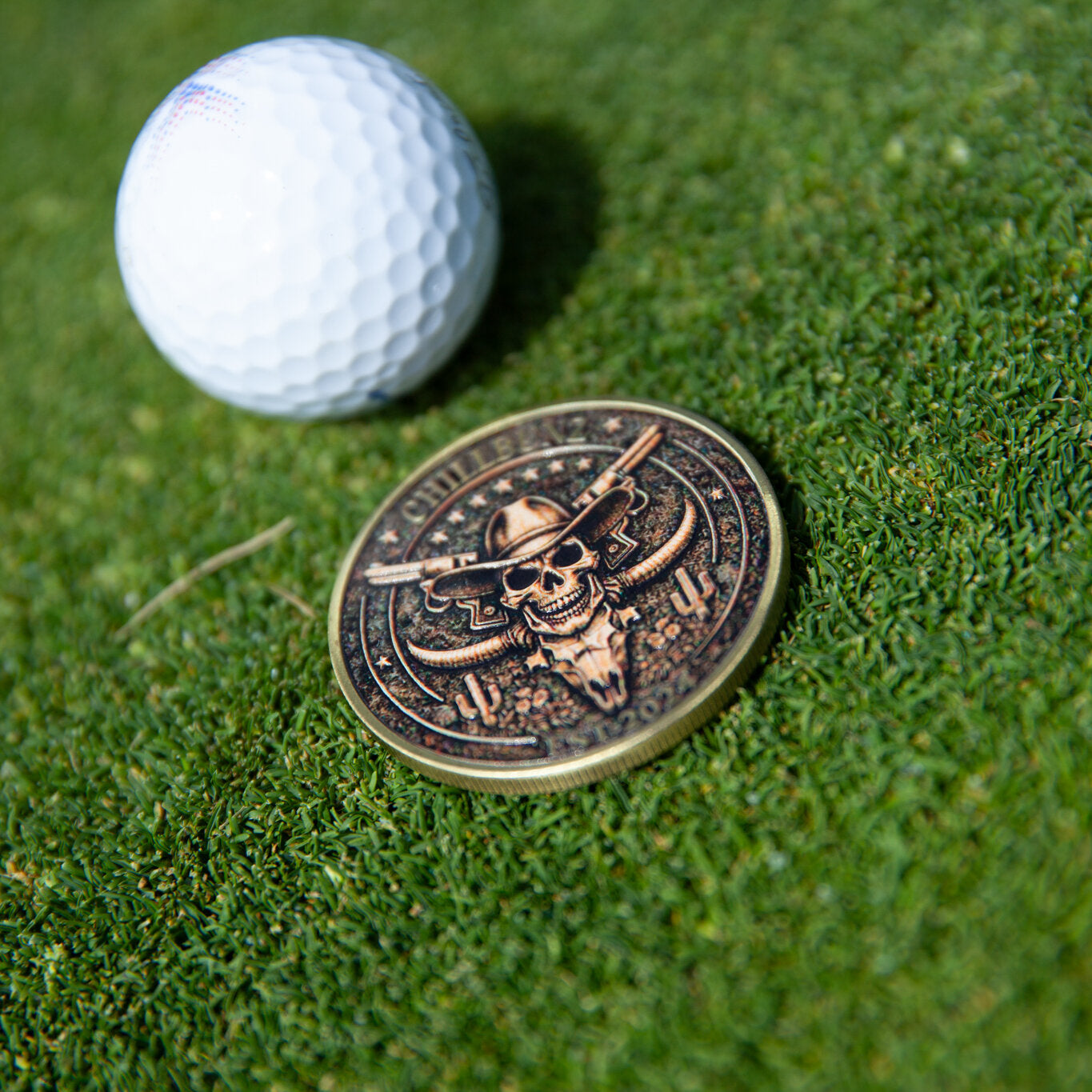 Outlaw Chill ball marker, metal horned skull design, on the green
